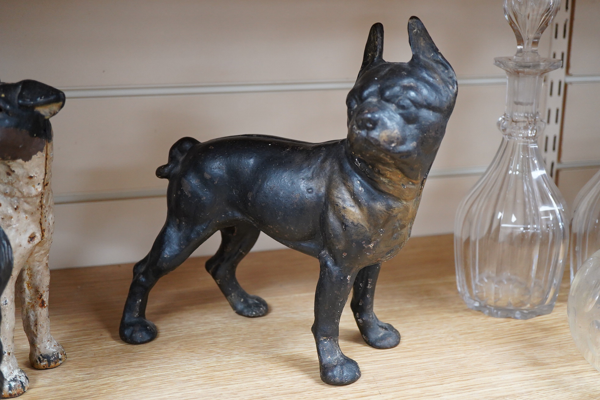 A group of three painted metal dogs, largest 25cm high x 23cm wide